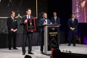 Co Founders of M&M Wealth Associates, Michael Henry and Matthew Wu, gives speech at FFS Convention after receiving recognition award.